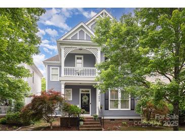 Charming two-story home with a covered front porch and manicured landscaping at 7043 Blakeney Greens Blvd, Charlotte, NC 28277