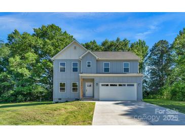 Charming two-story home with a light blue exterior, attached two-car garage, and well-maintained lawn at 7874 Lucky Creek Ln, Denver, NC 28037
