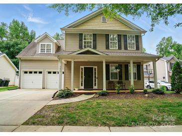 Charming two-story home with a welcoming front porch and well-manicured landscaping at 9856 Caldwell Depot Rd, Cornelius, NC 28031