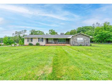 Charming single-story home featuring a large front yard and a mix of brick and stone accents at 111 Gordon Ave, Shelby, NC 28152