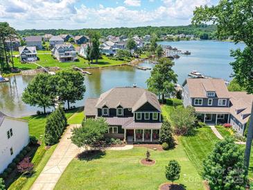 Stunning lakefront home with mature trees, lush lawn and private dock; perfect for relaxing and entertaining at 164 Twin Sisters Ln, Mooresville, NC 28117
