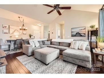 Spacious living room with a comfortable gray sectional sofa and plush ottoman on a decorative rug at 18605 Ruffner Dr # 3E, Cornelius, NC 28031
