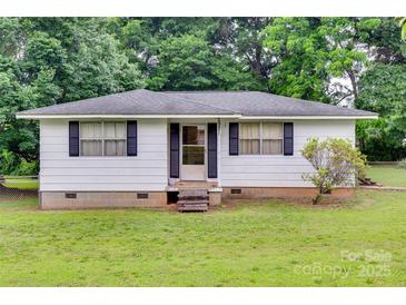 Charming single story home with a white exterior, black shutters, and well-maintained front lawn at 2921 Ambrose Dr, Gastonia, NC 28056