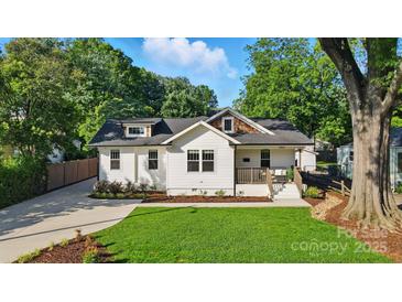 Charming exterior of a white two-story home with a well-manicured lawn and beautiful landscaping at 343 Melbourne Ct, Charlotte, NC 28209