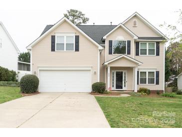 Charming two-story home featuring a two-car garage and a well-maintained lawn at 435 Riverwalk Nw Dv, Concord, NC 28027