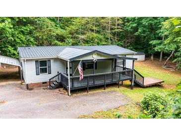 Charming single Gathering home with a covered front porch, dark trim, and a metal roof at 51 Emily Ln, Taylorsville, NC 28681
