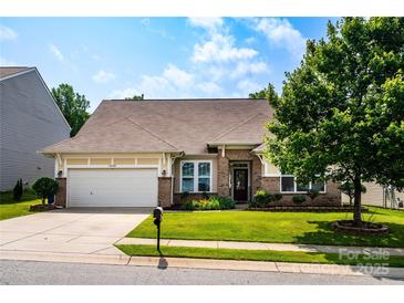 Charming single-story home with a well-manicured lawn, brick accents, and a two-car garage on a sunny day at 6038 Durango Way, Denver, NC 28037