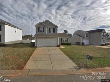Charming two-story home with a two car garage, and a traditional suburban landscape at 1540 Hollow Maple Dr # 122, Charlotte, NC 28216