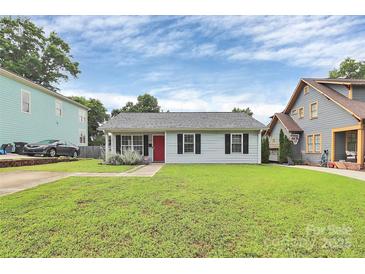Charming single-story home with a manicured lawn, red front door, and classic black shutters at 2117 Yadkin Ave, Charlotte, NC 28205