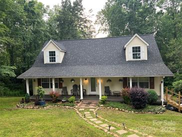 Charming two-story home with a welcoming front porch and meticulously landscaped front yard at 223 Tennessee Trl, Lincolnton, NC 28092