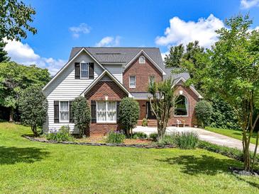 Charming two-story home with a well-manicured lawn, brick and siding exterior, and a delightful garden at 2325 Perry Rd, Denver, NC 28037