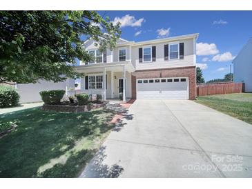 Charming two-story home with a well-manicured lawn and a two-car garage in a Gathering-friendly neighborhood at 3015 Liddington Rd, Matthews, NC 28105