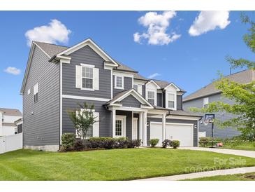 Beautiful two-story home featuring gray siding, white trim, and a well-manicured front yard at 4029 Spring Garden St, Fort Mill, SC 29715
