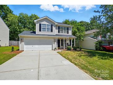 Charming two-story home with a two car garage, black shutters, and landscaped front yard at 820 Settlement St, Clover, SC 29710