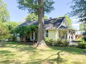 Charming single-story home with a welcoming front porch and a lush green lawn at 436 8Th Avenue Nw Dr, Hickory, NC 28601
