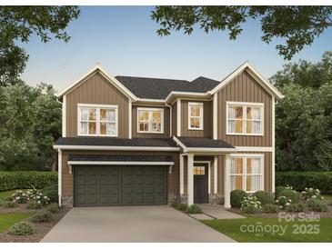 Two-story home with brown siding, a two-car garage, a landscaped yard and a dark roof and trim at 718 Lithia Inn Rd, Lincolnton, NC 28092