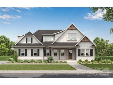 Charming two-story home with a covered front porch, black shutters, and lush landscaping at 770 Highway 274 Rd, Clover, SC 29710