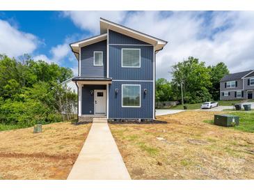 Modern two-story home with blue siding, white trim, and a well-maintained front yard at 304 Cabarrus W Ave, Concord, NC 28025