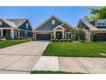 Charming home featuring stone accents, a well-manicured lawn, and an attached two-car garage at 4014 Pleasant Run Dr, Stallings, NC 28227