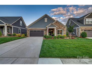 Charming single-Gathering home featuring a stone facade, well-manicured lawn, and an attached two-car garage at 4014 Pleasant Run Dr, Stallings, NC 28227
