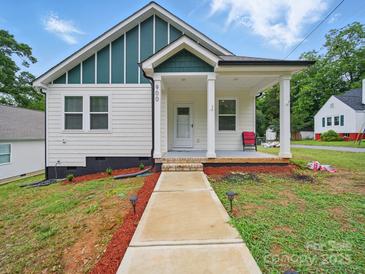 Charming bungalow with a welcoming front porch and freshly landscaped yard at 900 4Th St, Spencer, NC 28159