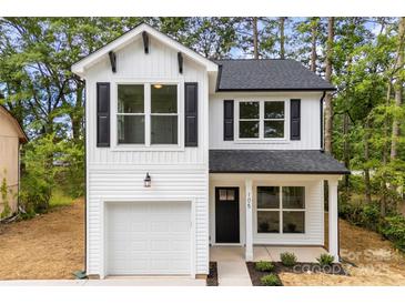 Charming two-story home with a white exterior, black shutters and a one-car garage at 105 Spring Garden Dr, Gastonia, NC 28052
