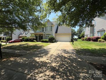 Charming two-story home with a well-manicured front yard and a two car garage at 2567 Holly Oak Ln, Gastonia, NC 28056