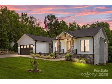 Charming home with stone accents, inviting front porch, and well-manicured lawn, all beneath a captivating twilight sky at 2577 Bonnybrook Cir, Rock Hill, SC 29732