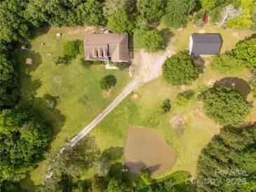 Expansive property featuring a house, outbuilding, pond, and lush surrounding greenery at 2818 Neill Rd, Lancaster, SC 29720