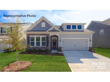 Charming single-Gathering home with a manicured lawn, stone accents, and an attached two-car garage at 3128 Spring Iris Dr, Denver, NC 28037