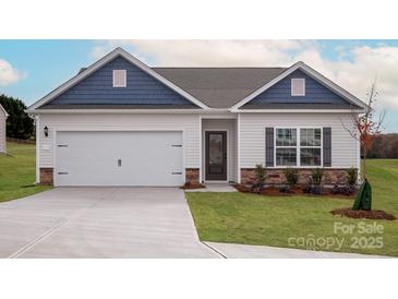 New construction home featuring a two-car garage, stone accents, and a well-maintained lawn at 3475 Saddlebred Dr, Gastonia, NC 28052