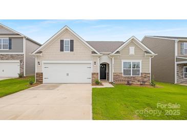 Charming single-Gathering home with a two-car garage, stone accents and well manicured lawn at 7905 Old Brook Rd, Sherrills Ford, NC 28673