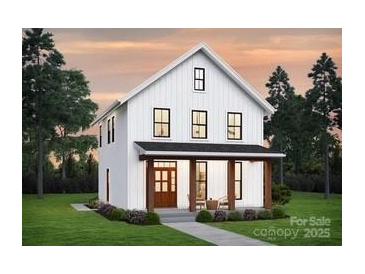 Charming two-story white farmhouse-style home with inviting front porch and manicured lawn at 0000 Trull Hinson Rd # 2, Wingate, NC 28174
