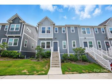 Charming townhouse with a well-maintained lawn, inviting entryway, and modern gray siding at 1015 Maltby St, Charlotte, NC 28217