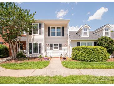 Charming townhome with manicured lawn, walkway, and inviting curb appeal at 10945 Winterbourne Ct, Charlotte, NC 28277