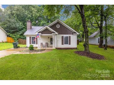 Charming one-story home with well-manicured lawn and cozy front porch at 124 Cedarcroft Dr, Mooresville, NC 28115