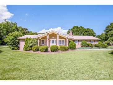 Charming brick home with a well-manicured lawn and mature landscaping at 2078 Valley View Ln, Lincolnton, NC 28092
