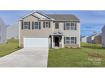 Charming two-story home with a well-manicured lawn and a two-car garage in a suburban neighborhood at 2629 Goose Fair Rd # 61, Maiden, NC 28650