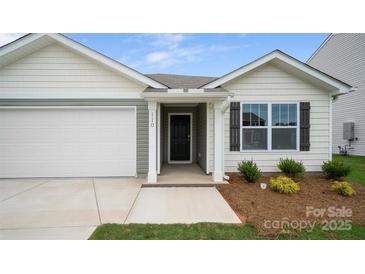 Charming home featuring a covered front door, neat landscaping, and an attached garage, creating inviting curb appeal at 2656 Goose Fair Rd # 126, Maiden, NC 28650