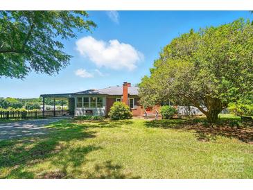 Charming single-story home featuring a brick chimney and well-maintained front lawn with mature trees at 2722 Catawba Church Rd, Rock Hill, SC 29730