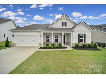 Charming home boasts a well-manicured lawn, white exterior, and inviting front porch at 3255 Split Rail Ln, Lancaster, SC 29720