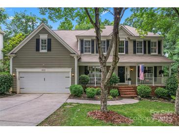 Charming two-story home with a covered front porch, two car garage, and well-manicured lawn at 5233 Fairvista Dr, Charlotte, NC 28269