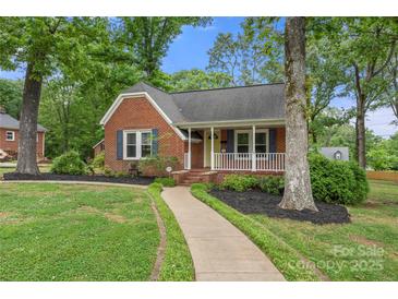 Charming brick home with a welcoming front porch and well-manicured landscaping at 725 W Graham St, Shelby, NC 28150