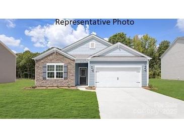 Charming single-Gathering home with stone accents, a two-car garage, and lush green lawn at 7913 Old Brook Dr, Sherrills Ford, NC 28673