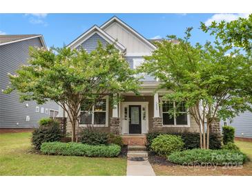 Charming home with a welcoming front porch, featuring stone accents and mature landscaping at 1020 Bannister Rd, Waxhaw, NC 28173
