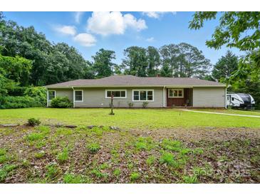 Charming single story home with a well-maintained lawn and mature trees at 1038 Blake Rd, Albemarle, NC 28001