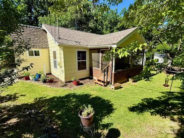 Charming home with screened-in porch, lush lawn, and beautiful landscaping in a serene, tree-filled setting at 105 Venus Ave, Gastonia, NC 28052
