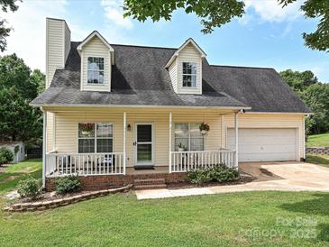 Charming home with a welcoming front porch, attached garage, and well-maintained lawn and landscaping at 1505 Wimbleton Woods Dr # 5, Fort Mill, SC 29708