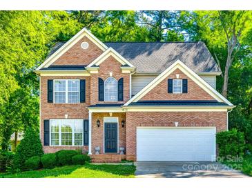 Charming two-story brick home with a well-maintained lawn and lush green trees, creating a welcoming curb appeal at 1648 Jonesberry Dr, Rock Hill, SC 29732