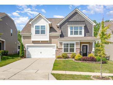 Charming two-story home with a manicured lawn, lovely landscaping, and a two-car garage at 1659 Loggerhead Dr, Lancaster, SC 29720